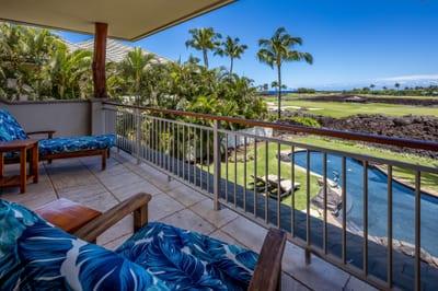 The primary bedroom's private lanai features comfortable seating and ocean views