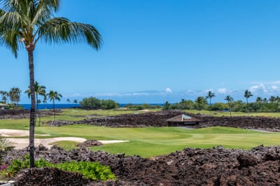 Enjoy fairway and ocean views from the private upstairs lanai and den