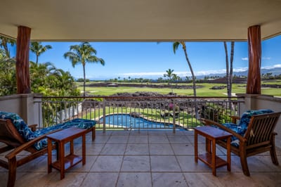 The covered lanai overlooks the tropical landscaping and fairway below
