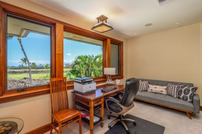 The den features a comfortable seating area in addition to the private workspace
