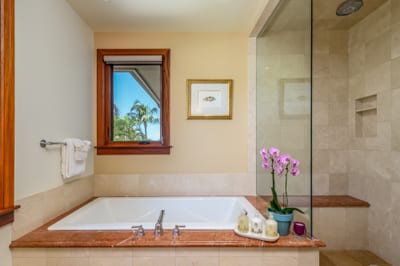 The primary bath offers a deep soaking tub and a spacious walk-in shower