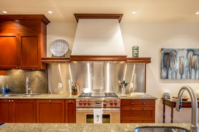 The kitchen features an industrial style stove and oven, perfect for a private chef