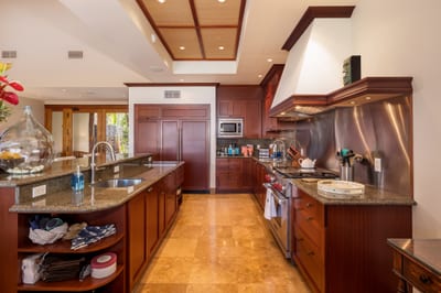 Dark wood cabinetry and stainless appliances give the kitchen a refined, polished feel