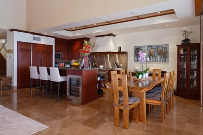 A second dining angle shows the full table setting and the warm, open atmosphere