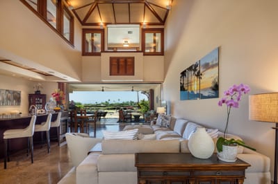 The main living area features high ceilings, wood details, and an open, airy layout