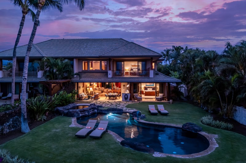 An aerial view captures the home's architecture set among rich greenery