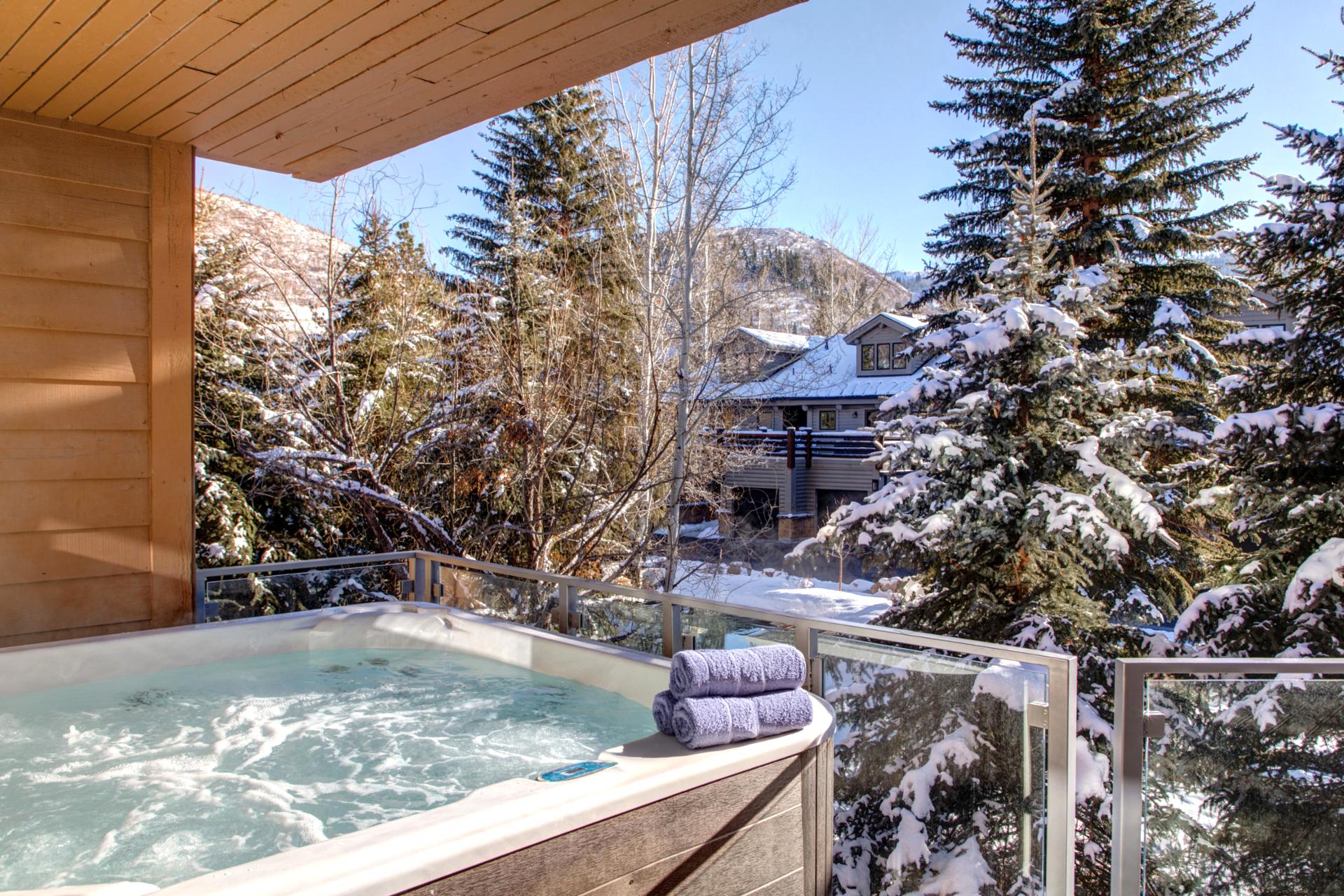 Private outdoor hot tub with peaceful forest and mountain views.