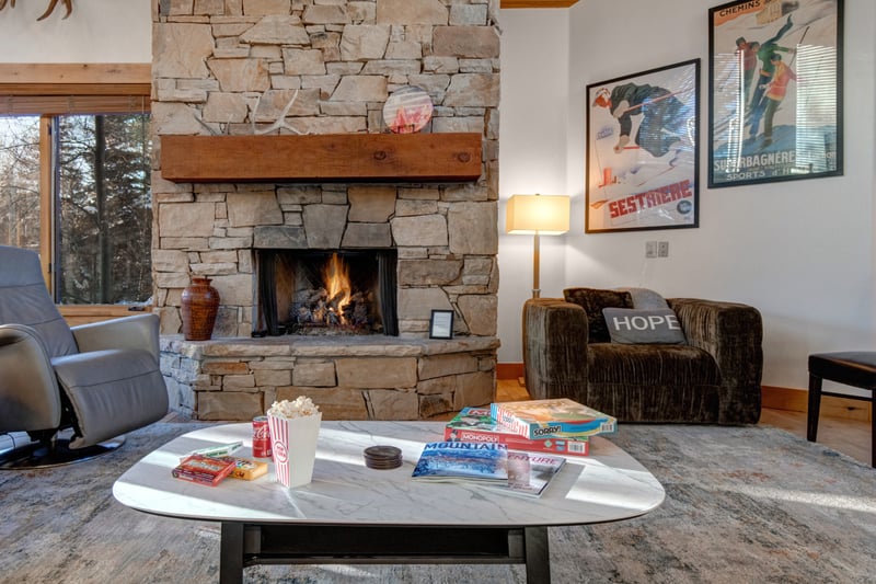 Settle into comfortable seating around the fireplace, a welcoming living room for conversations, reading, or winding down after a full day out.