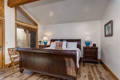 Warm wooden floors, a king-size bed, TV, and a cozy gas fireplace—comfort and style in one inviting space