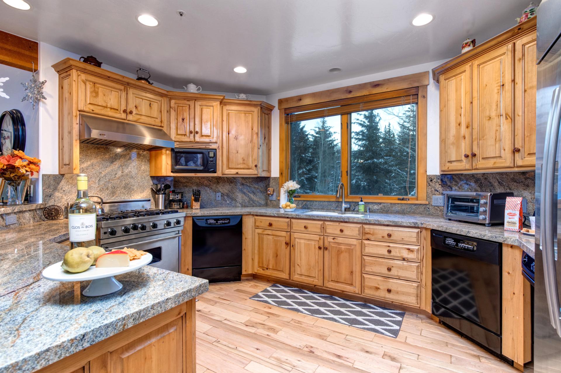 Warm wood cabinets framing a sunlit window—classic kitchen charm