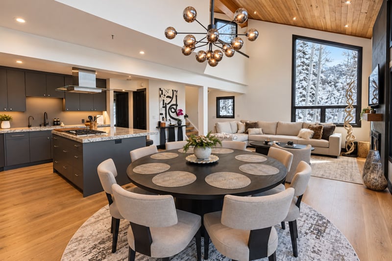 An open-concept kitchen and dining area, sophisticated and expansive windows.
