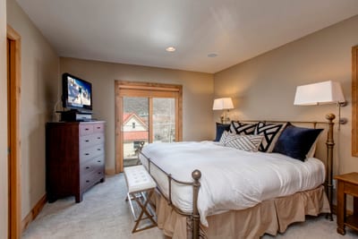 The primary bedroom includes a plush King bed, Smart TV, and an ensuite bath on the lower level.
