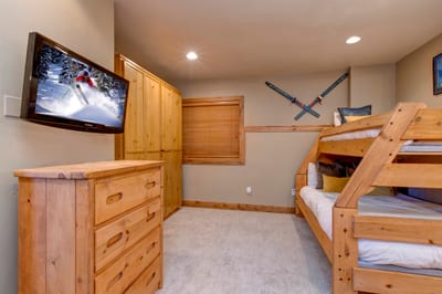 The guest room includes two bunk beds, a Queen Murphy bed, and a TV. Perfect for movie nights or group stays.
