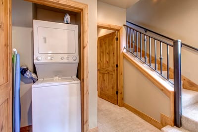 Laundry room with full-size washer and dryer keeps everything fresh for longer visits.