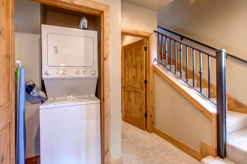 Laundry room with stackable washer and dryer keeps everything fresh for longer visits.