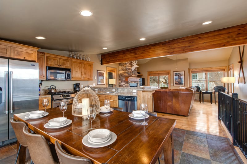 Gather around the dining table for six, set against warm wood tones that create the ideal setting for family dinners and game nights.