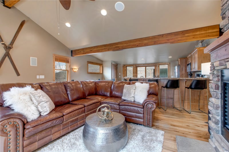 Lodge-inspired comfort fills the main living room, with vaulted ceilings and soft leather seating.