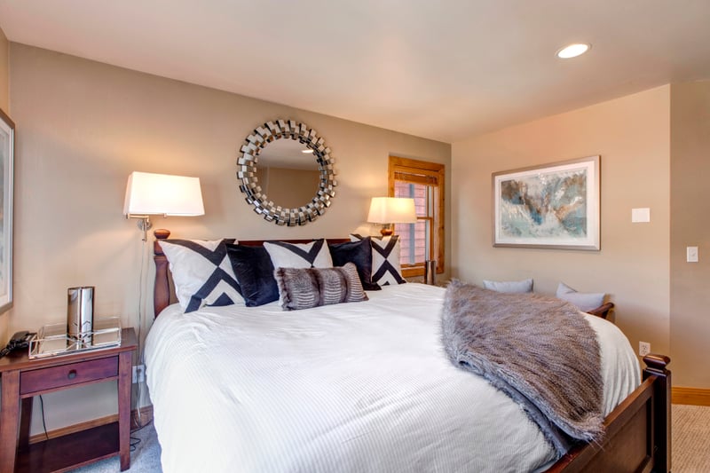Cozy, stylish bedroom with elegant decor and warm ambient lighting.