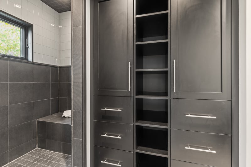 Additional view of guest bath shows sleek built-ins and hotel-style finishes.