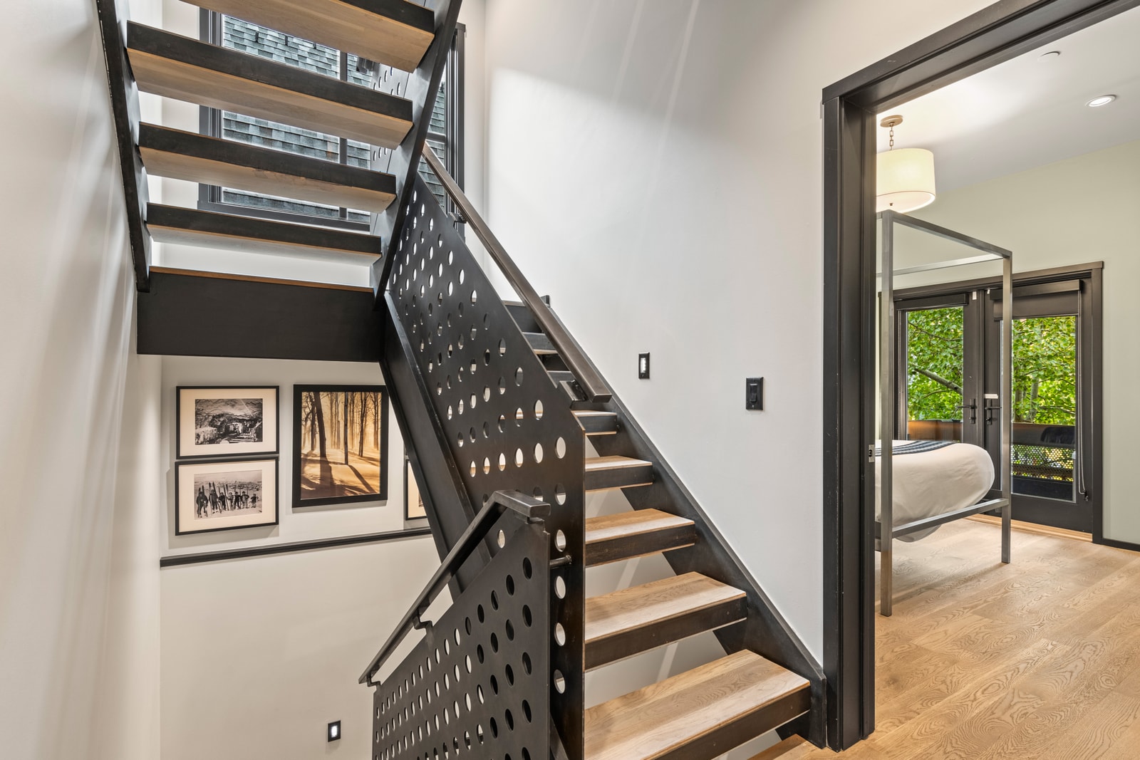 This central landing connects sleeping areas with clean lines and open railing.