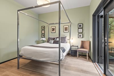 Queen bed, luxe four-poster frame, and private access to outdoor space define this serene guest room. PEA-1114
