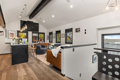 Wide-angle view of the living and kitchen area highlights spacious layout and natural light. PEA-1114