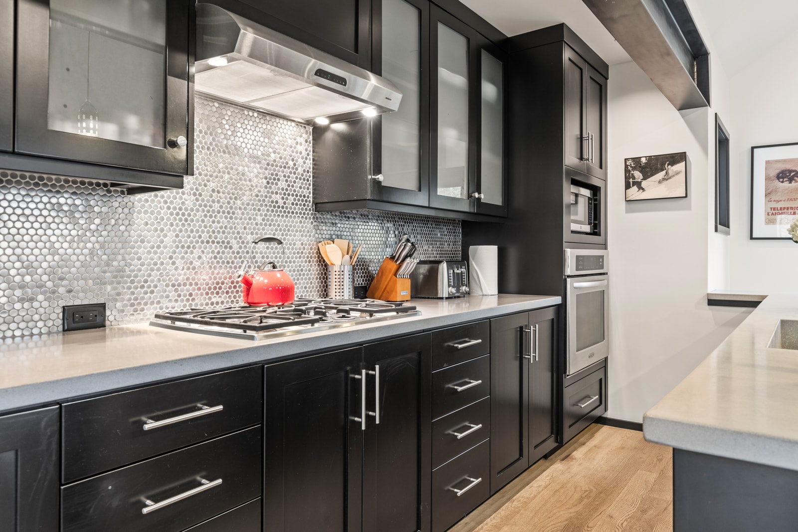 Full-length cabinetry, tile backsplash, and streamlined design offer both beauty and utility.
