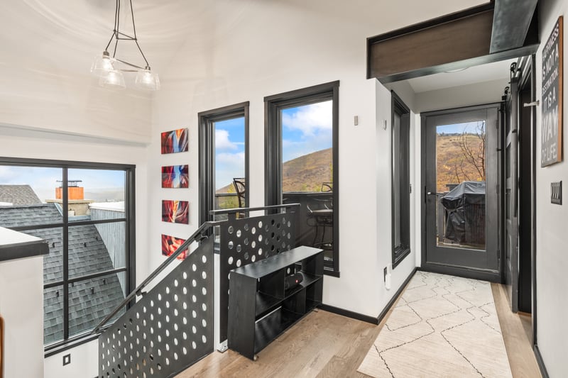 Upper level exit to balcony with BBQ and firepit table for outdoor gatherings PEA-1114