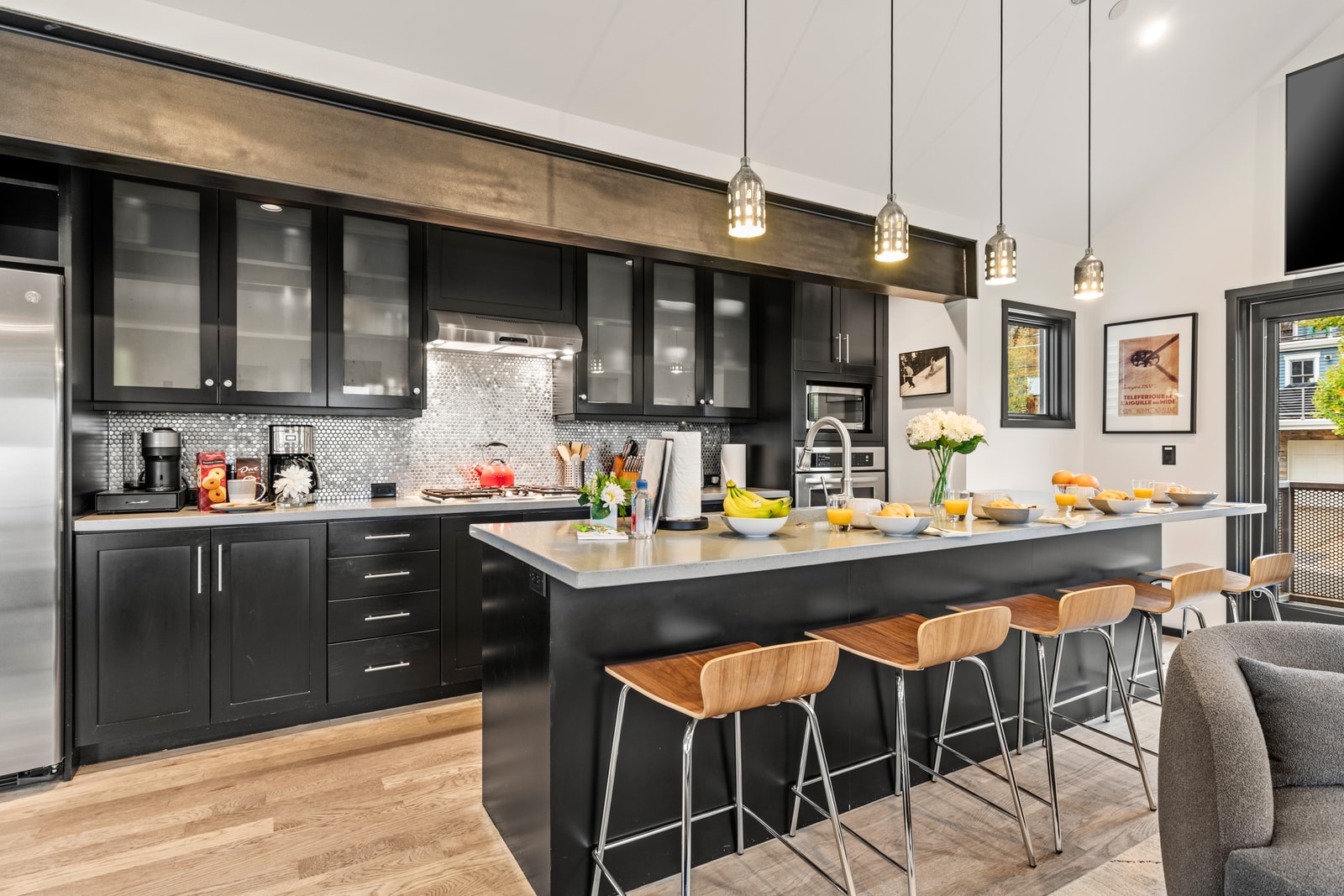 Sleek black cabinetry, pendant lighting, and island seating make this modern kitchen both functional and inviting.