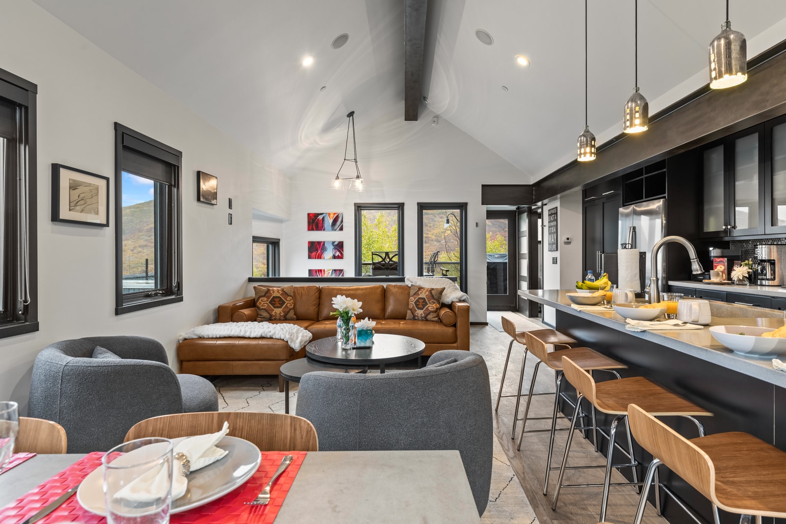 Open-concept living area with vaulted ceilings and stylish furnishings brings everyone together in one bright space.