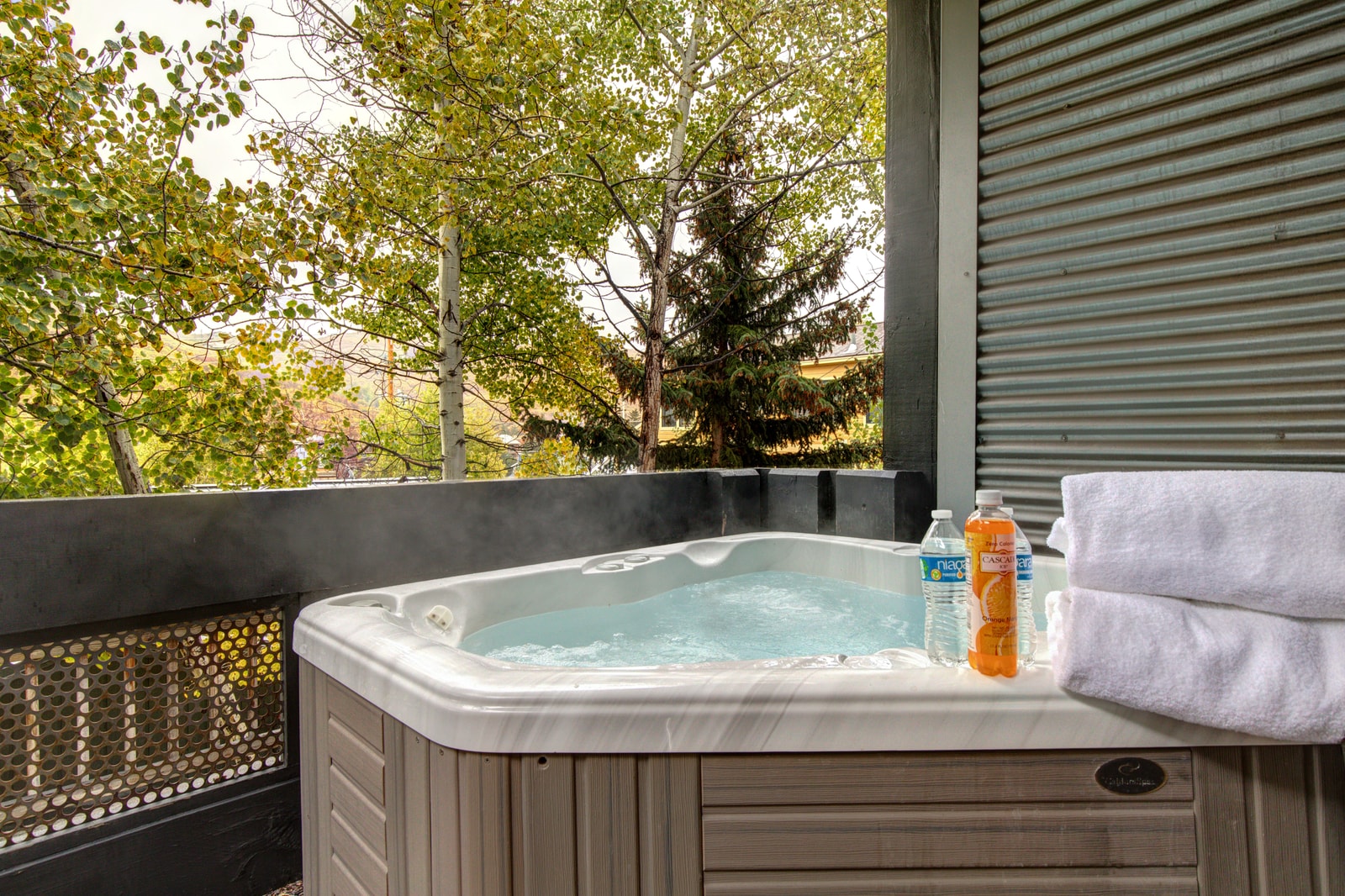 Private hot tub tucked under the trees offers the perfect après-ski soak or evening wind-down.
