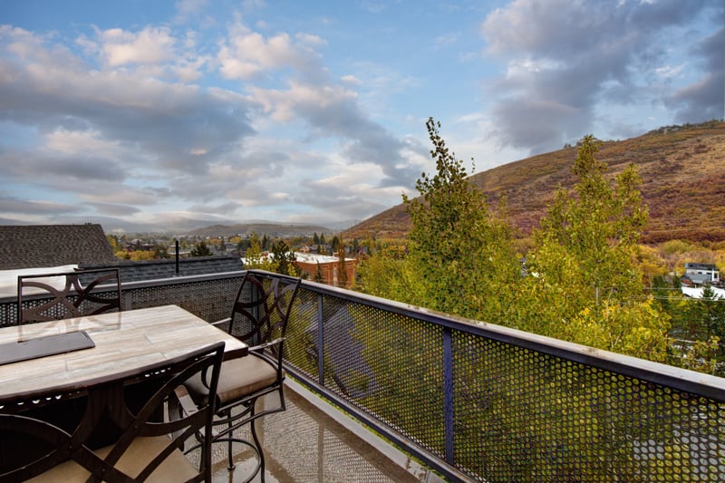 Balcony with full outdoor dining setup and sweeping valley views invites you to dine outside. PEA-1114