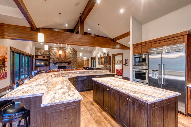 Cook with ease in the open chef’s kitchen with a wraparound island, stainless appliances, and seating for five.