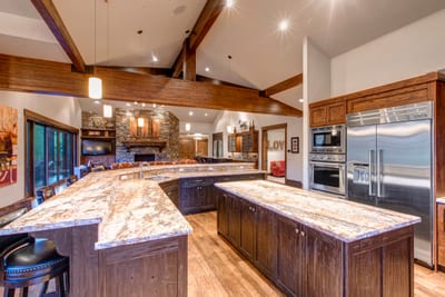 Cook with ease in the open chef’s kitchen with a wraparound island, stainless appliances, and seating for five.