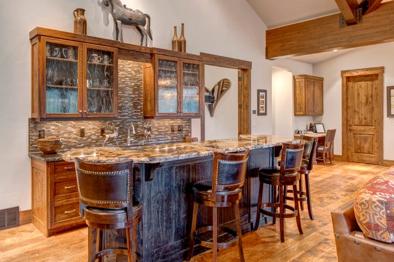 Gather for appetizers or cocktails at the bar with seating and stylish lighting.