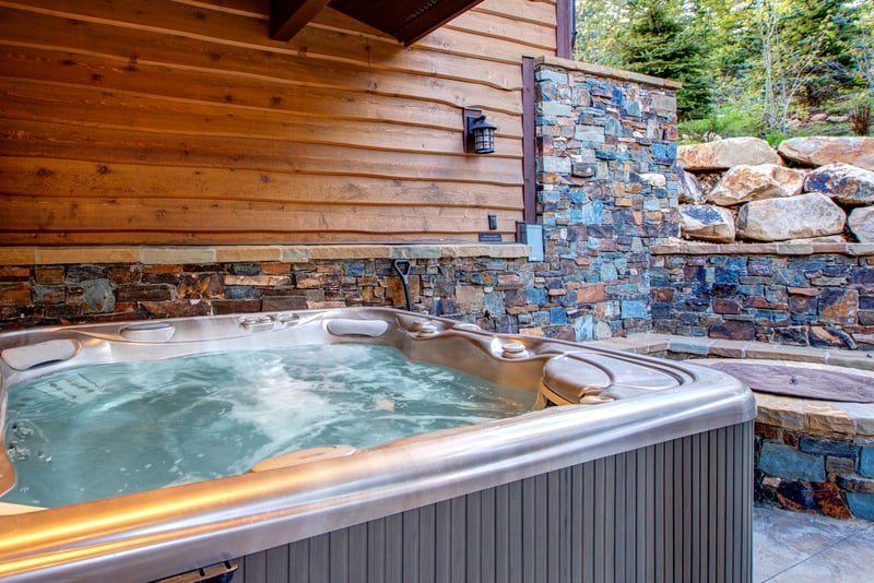 Soak under the stars in your private hot tub surrounded by trees and natural stone.