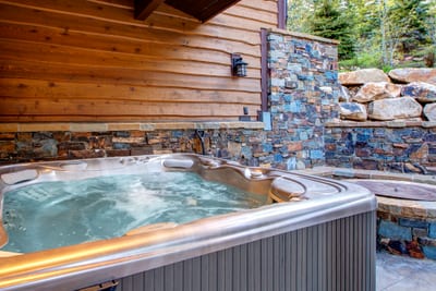 Soak under the stars in your private hot tub surrounded by trees and natural stone.