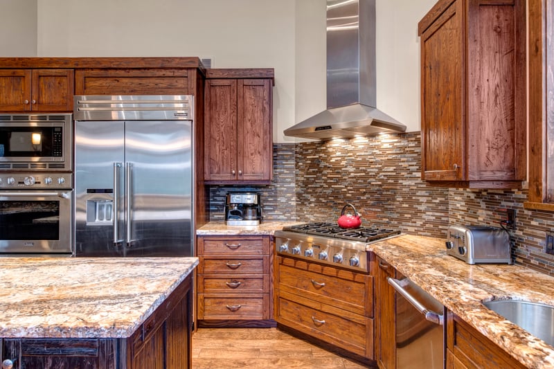 A chef’s kitchen with granite counters and gas range makes meal prep feel effortless.