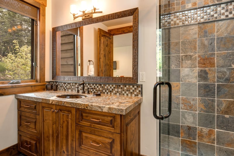 A walk-in shower and rich stone finishes elevate the ensuite.