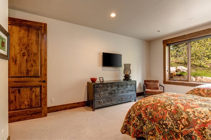 This inviting guest room includes warm wood furnishings and soft lighting for a restful stay.