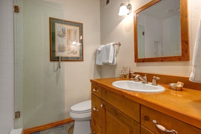Guest Bath 4 serves the bunk room and features walk-in shower and modern fixtures.