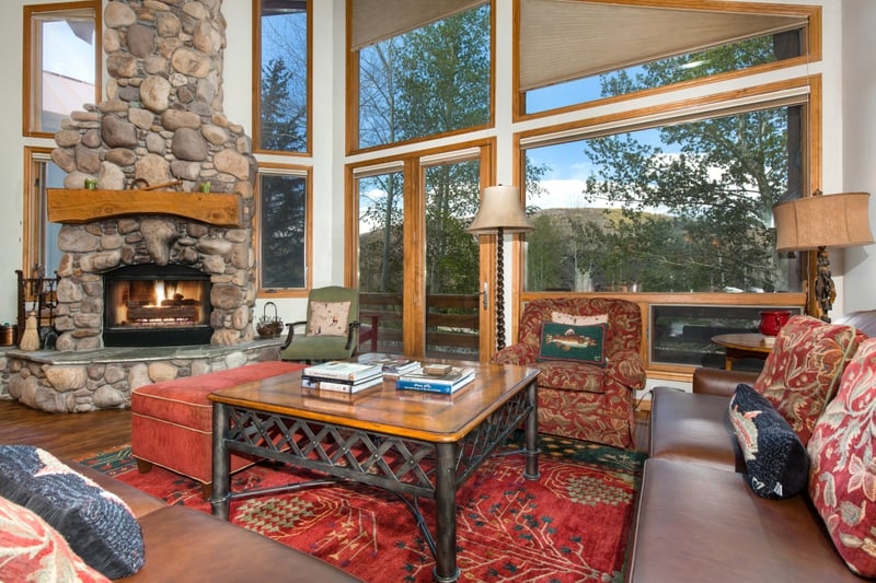 Warm yourself with this rock enclosed wood fireplace while reading a book in the living room