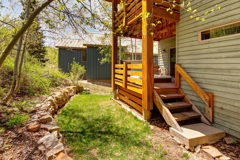 Outdoor stairs lead through aspens and evergreens for a full mountain experience.