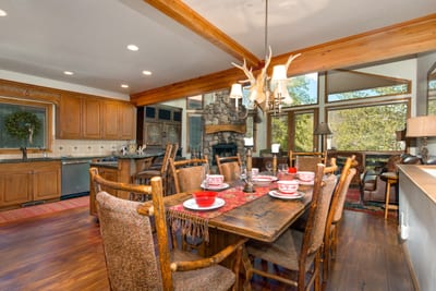 Dining for 6 with antler chandelier and scenic window views.