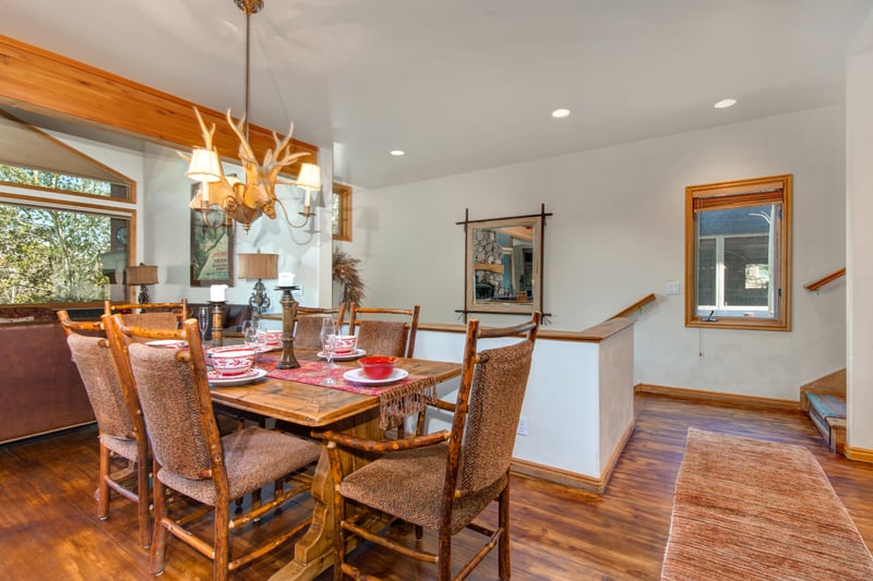 Alternate view of dining area with warm lighting and casual mountain charm.