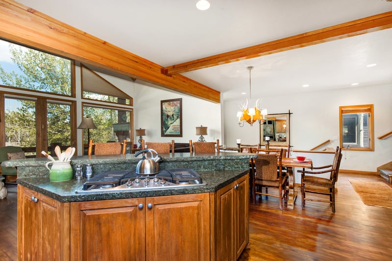 Additional angle of the kitchen shows generous cabinetry and convenient deck access.