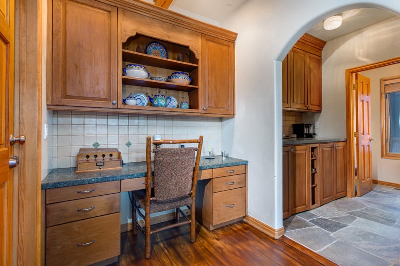 Kitchen includes a built-in desk and pantry, adding workspace and storage.