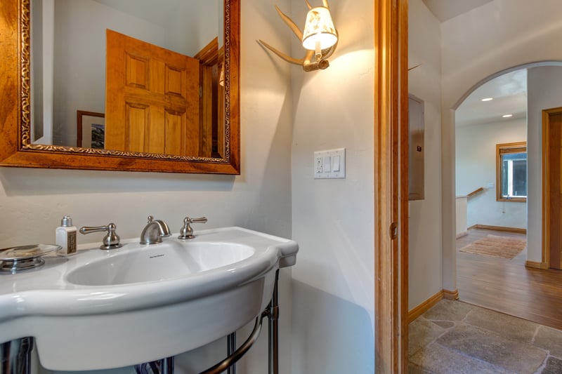 Guest Bathroom, a half bath near the kitchen, offers quick access for main level convenience.