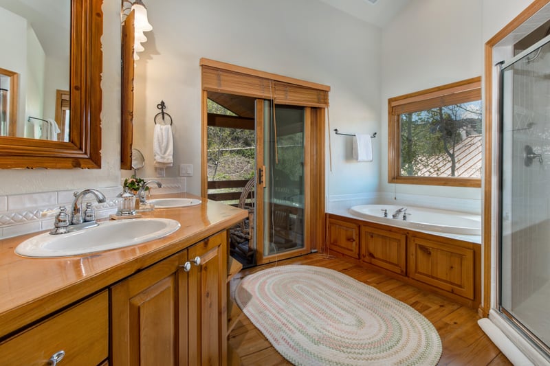 Primary bath includes a separate soaking tub, walk-in shower, and dual sinks.