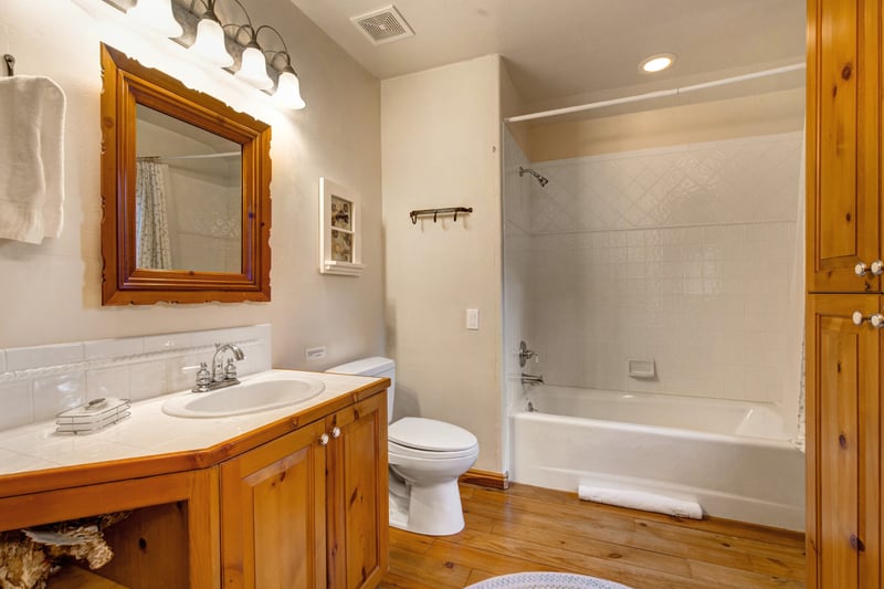 A shared full bath for Guest Bedrooms 2 and 3 with a clean, bright layout.